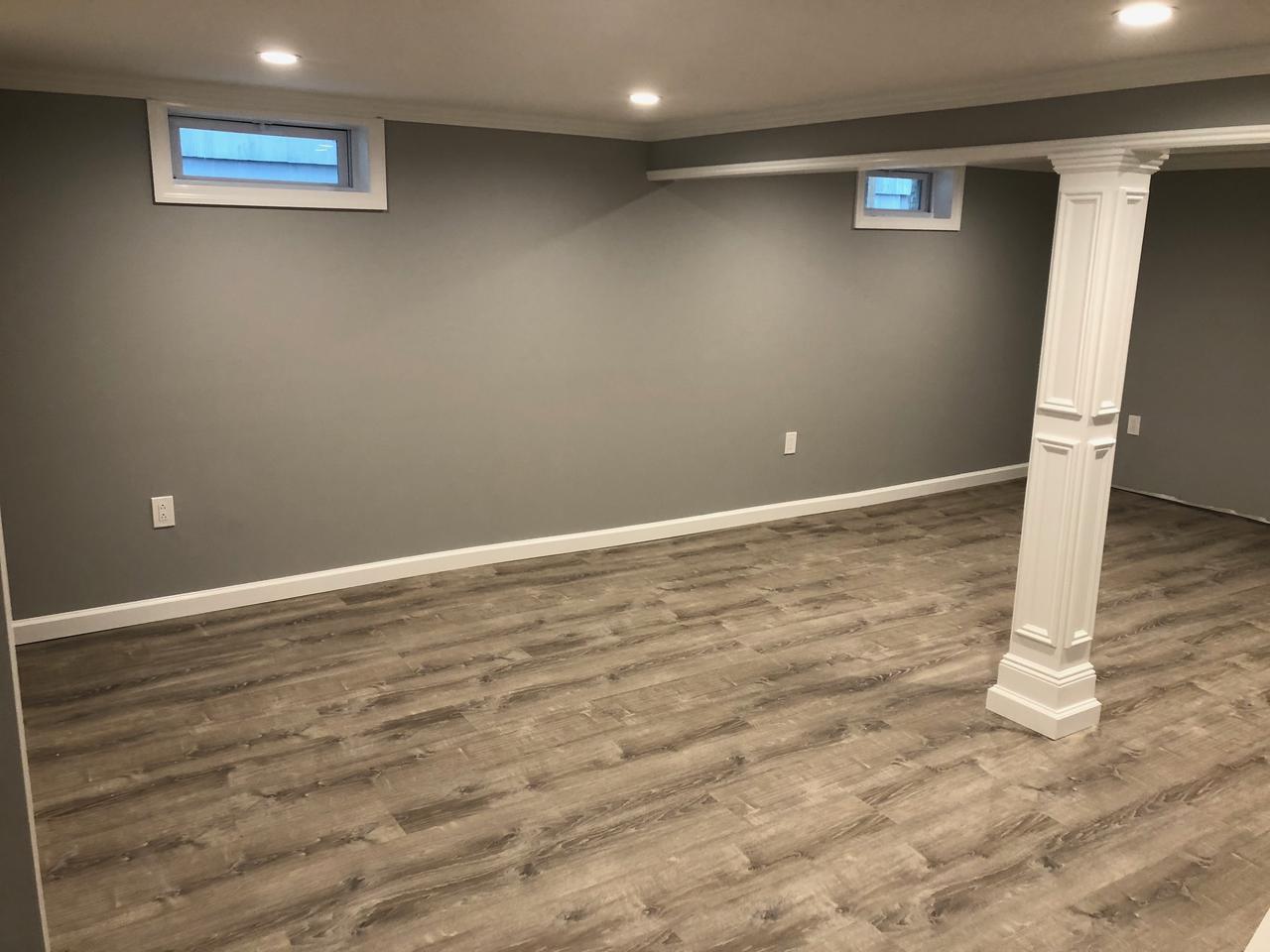 Finished basement with wrapped column after
