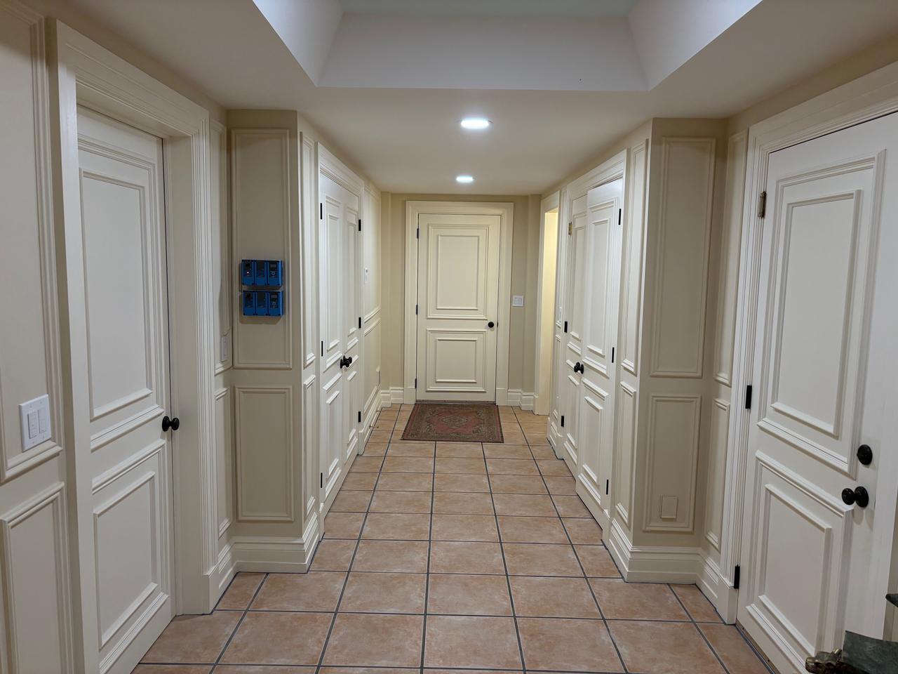 Hallway with painted paneled doors and trim after