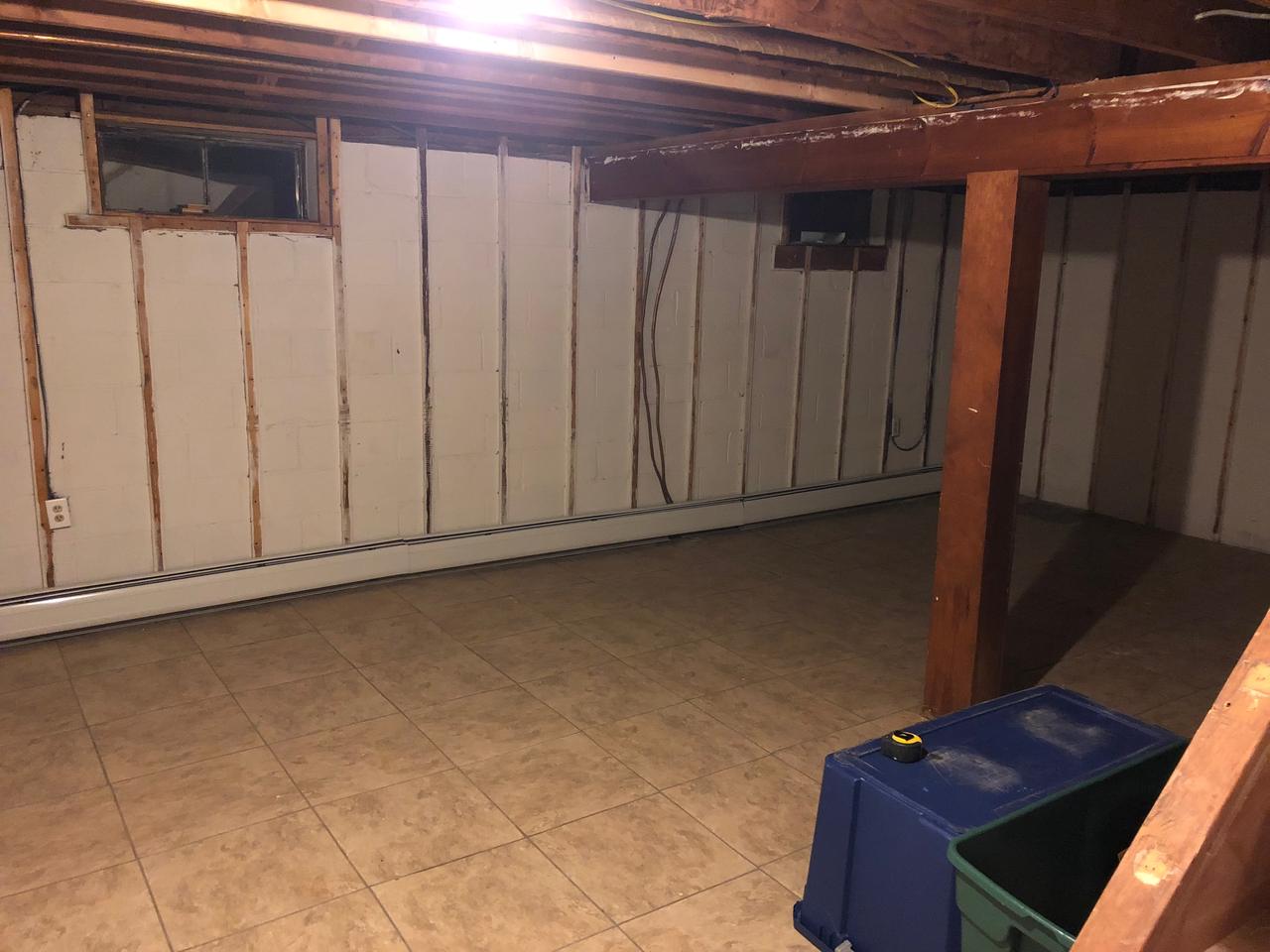 Unfinished basement with exposed framing before