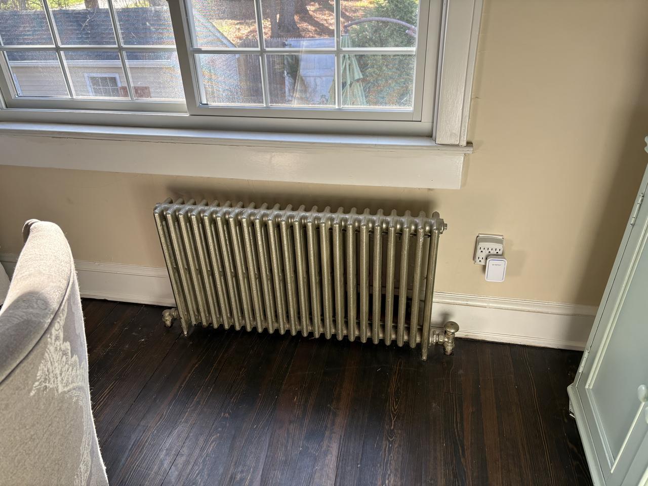 Bare cast-iron radiator before