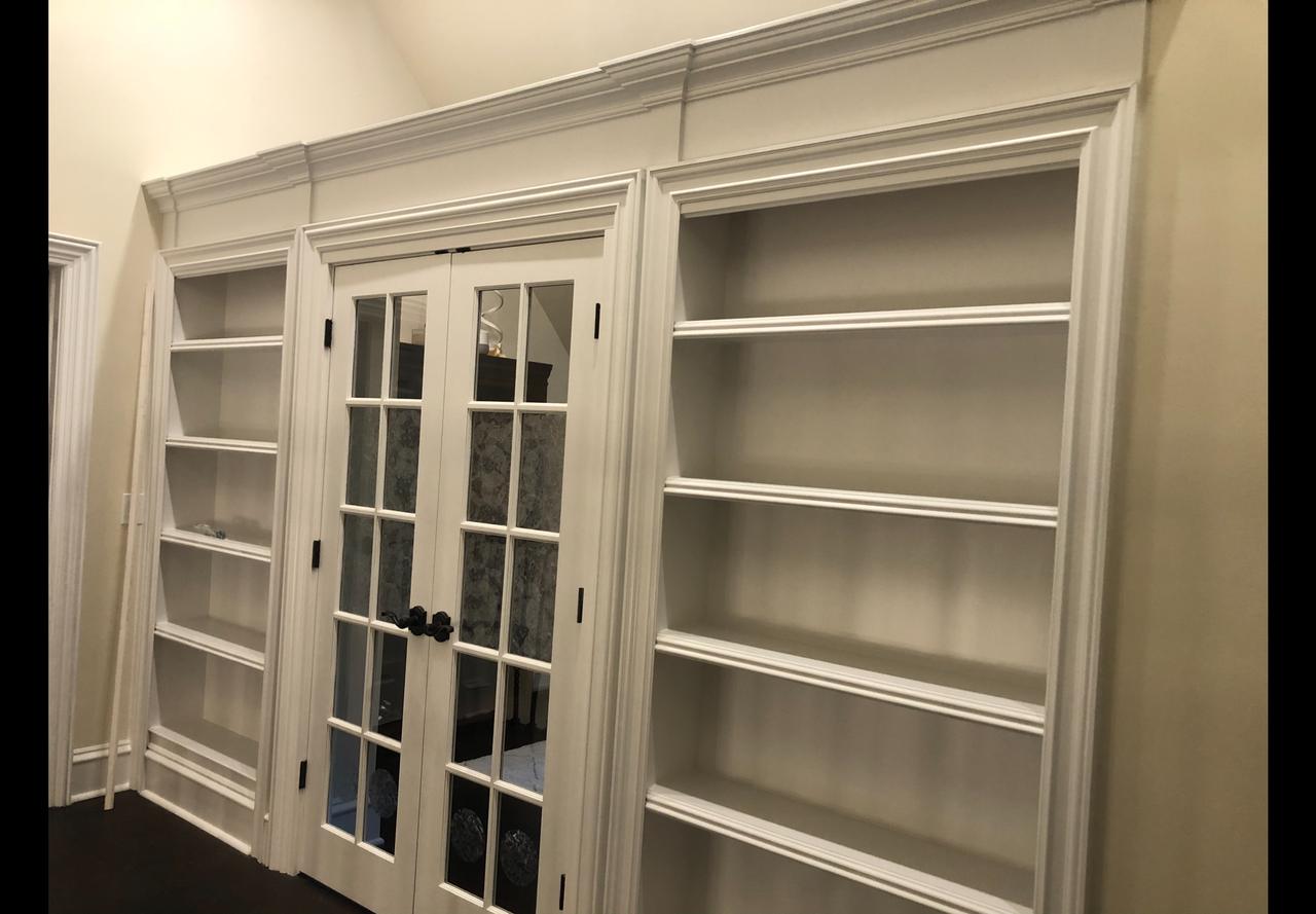 White built-in bookcase with glass French doors