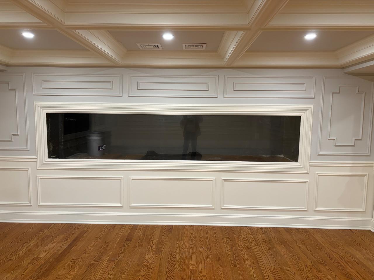 White built-in cabinetry with recessed TV nook
