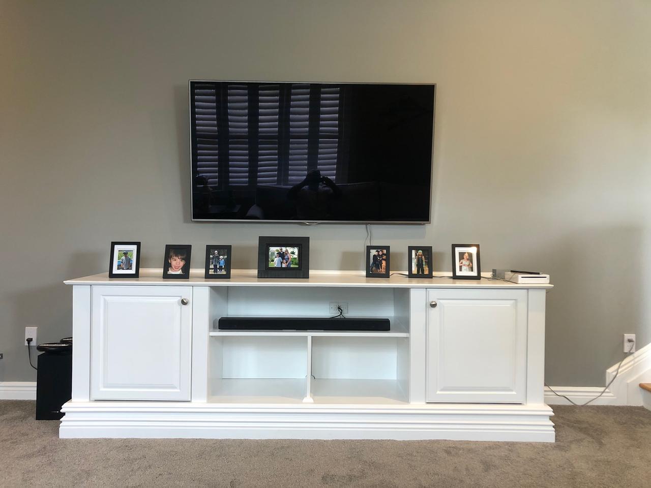 Cream built-in TV cabinet with shelving