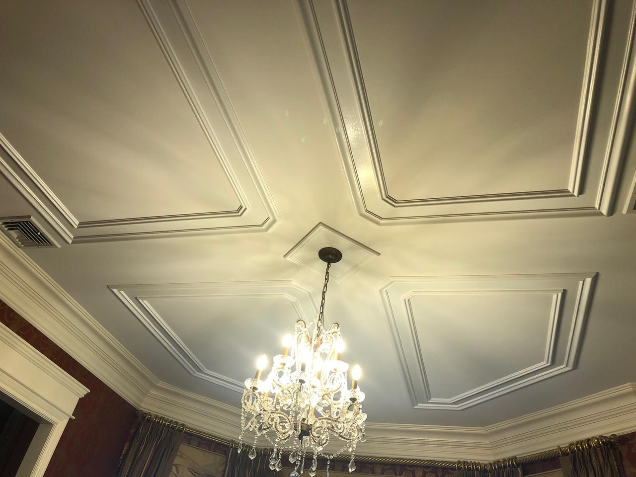 Ornate coffered ceiling with chandelier