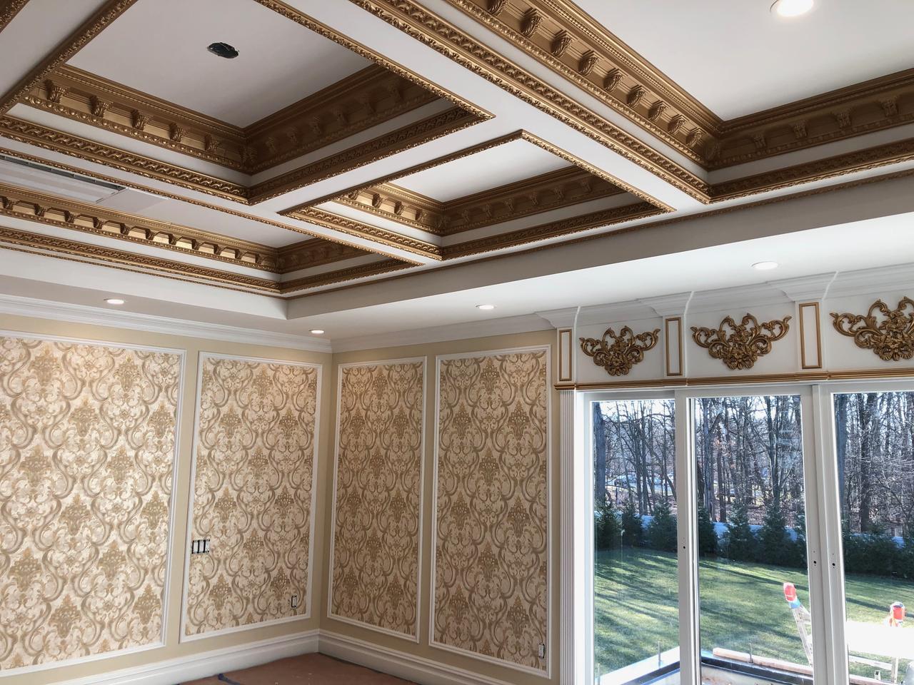 Ornate gold-trimmed coffered ceiling in a dining room