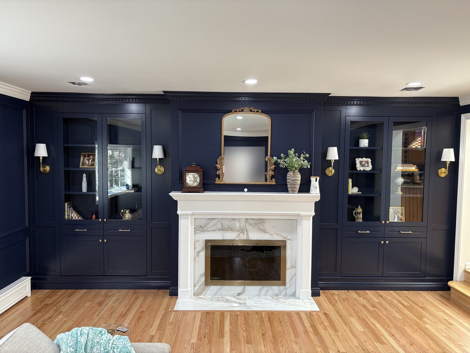 Marble fireplace mantel with navy built-in cabinetry