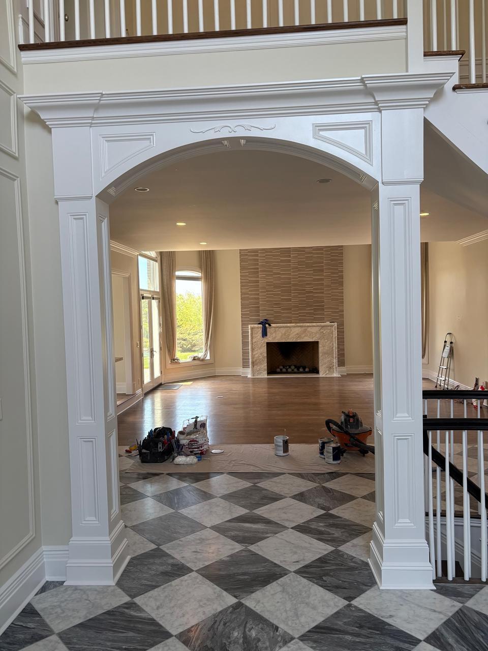 Archway with fireplace and checkerboard marble floor