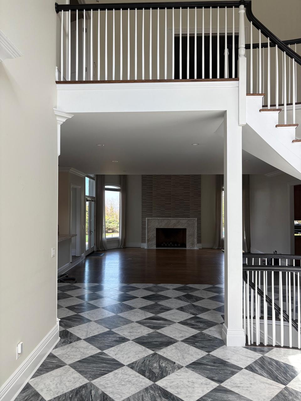 Two-story foyer with checkerboard marble floor