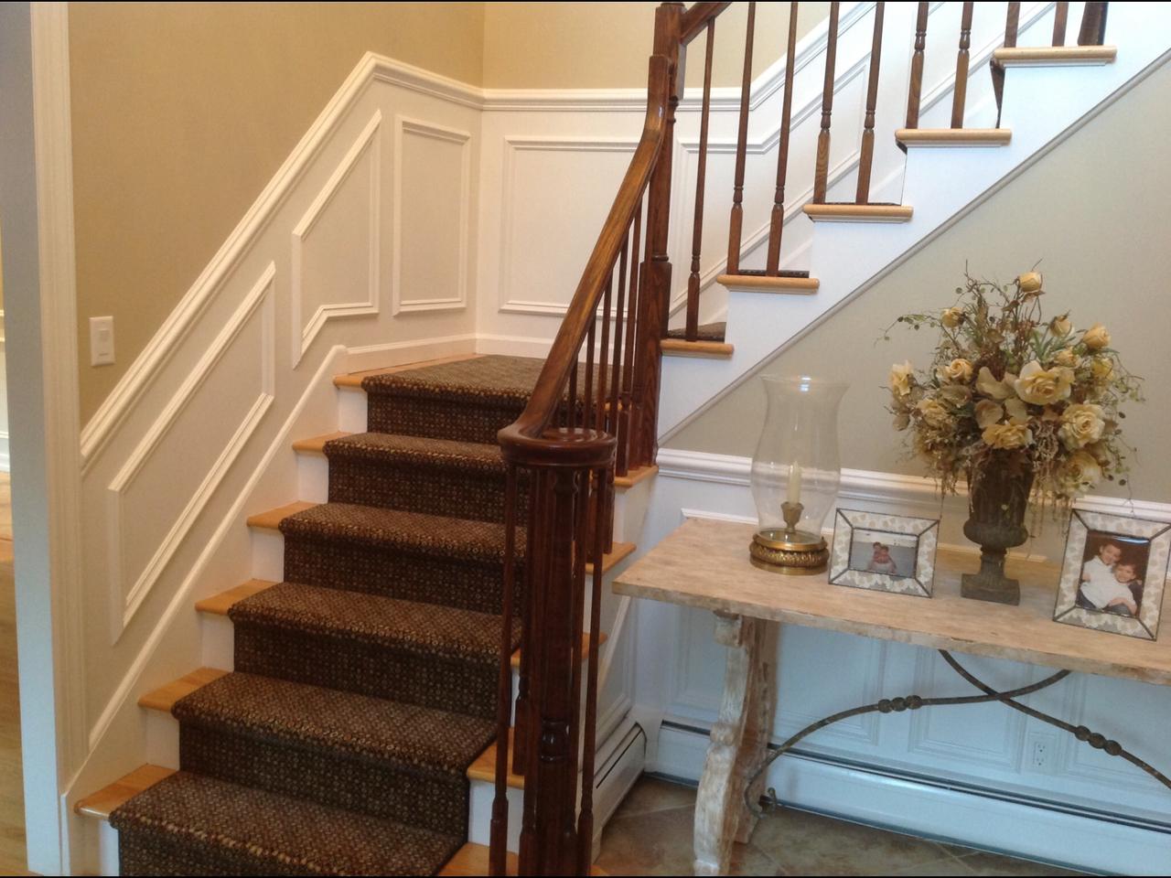 Staircase with console table and wainscoting