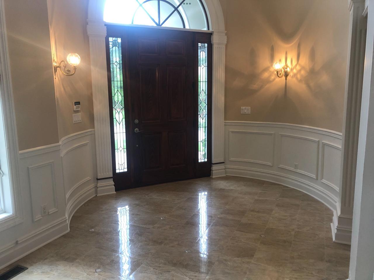 Entry foyer with staircase and marble floor