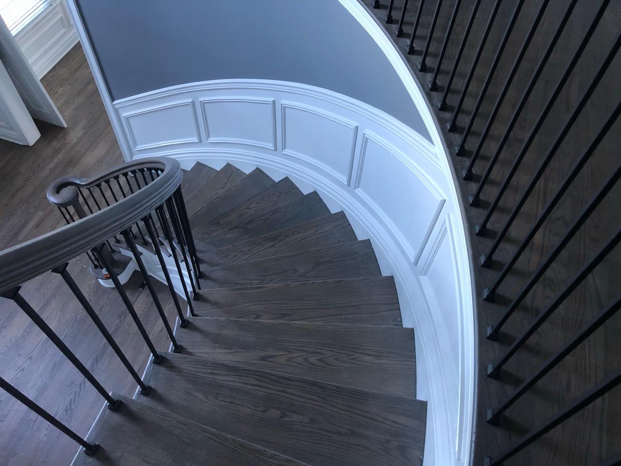 Curved entryway with staircase and wainscoting