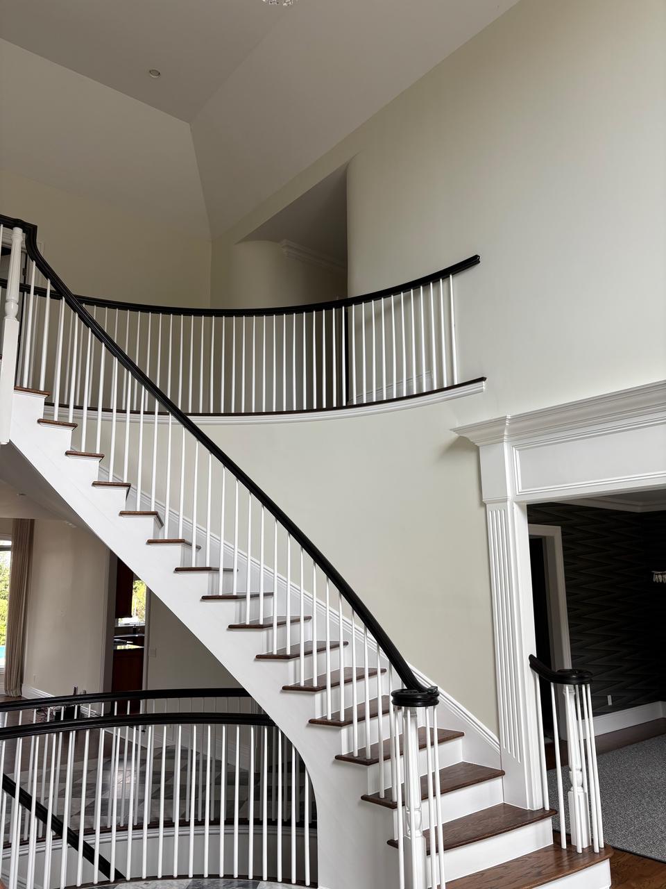 Staircase with white painted iron railing