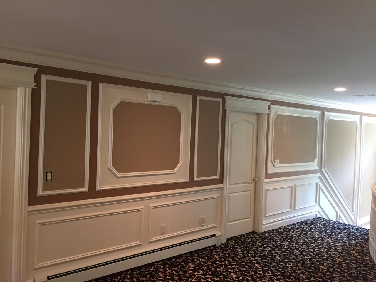 Two-tone raised panel wainscoting with pendant light