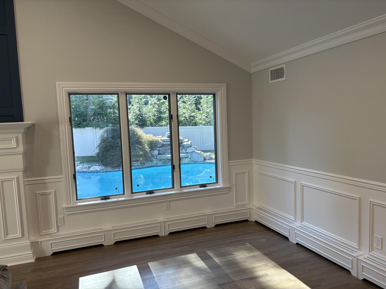 Wainscoting wrapping a bay window wall